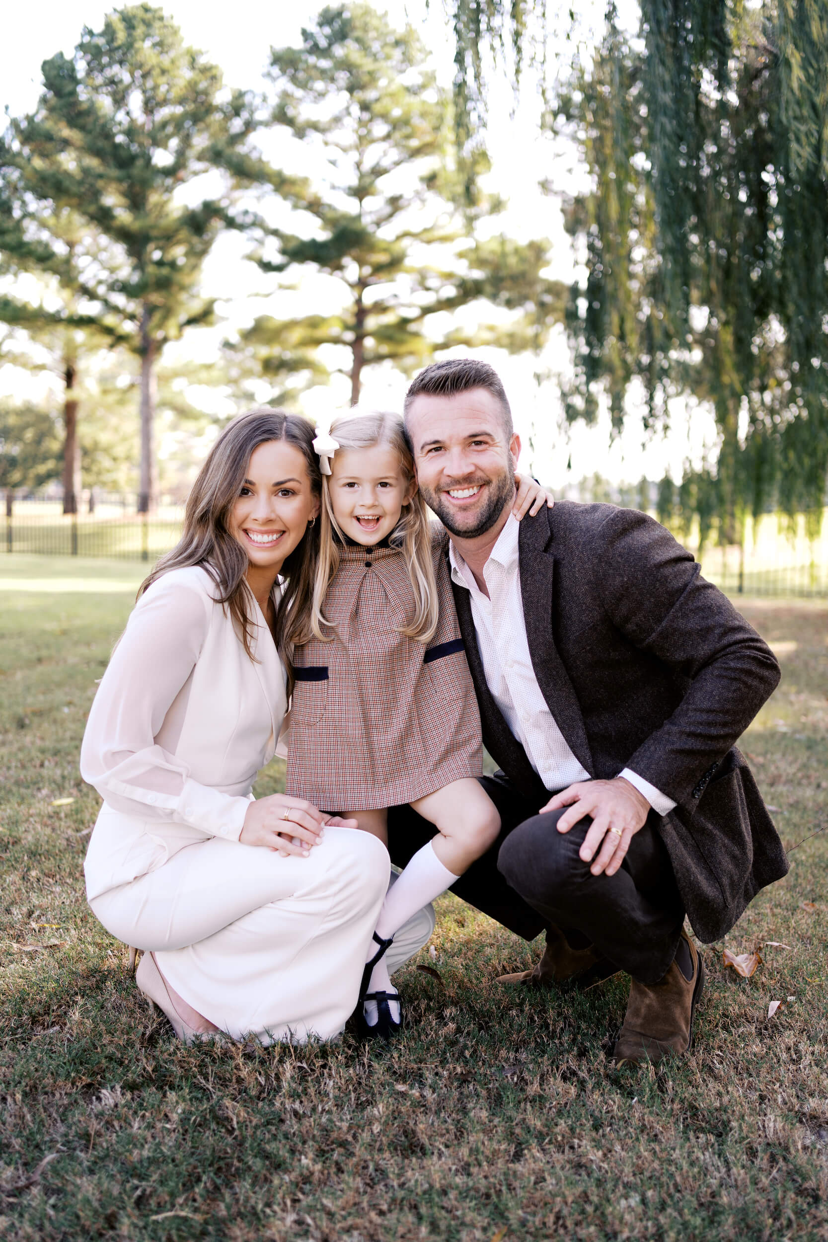 Family smiling together outside