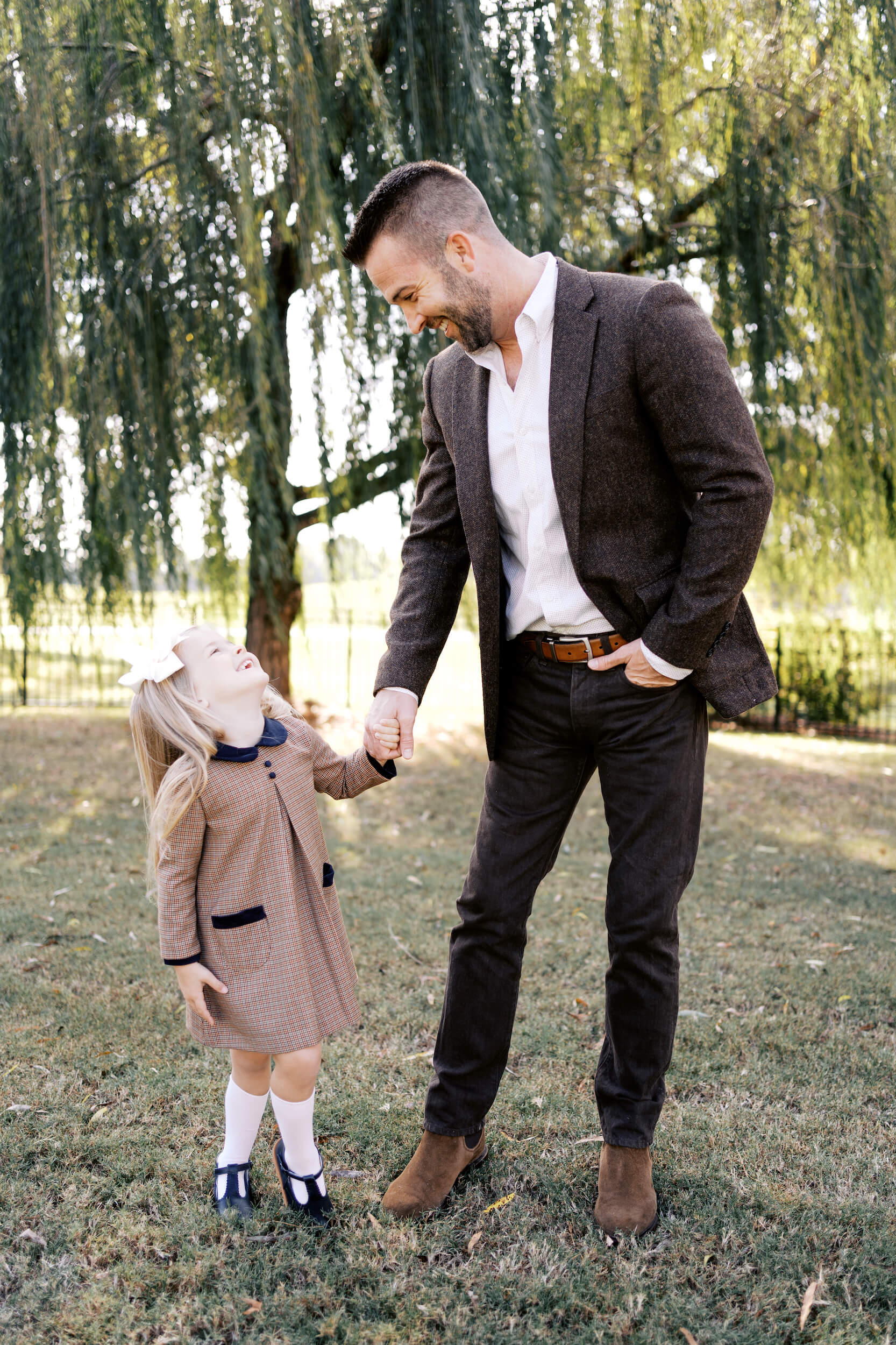 Child smiling at dad with playing in front of the tree after visiting Child's Play Therapy Center